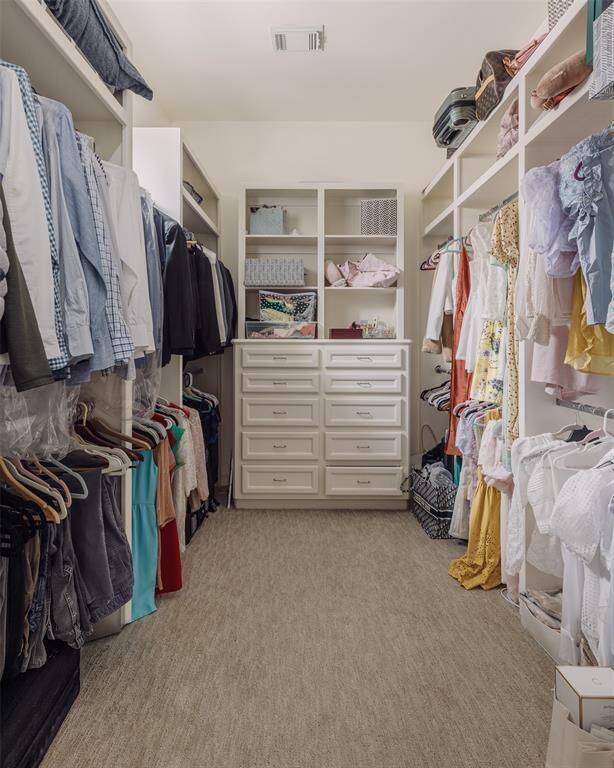 large walk in closet with built ins