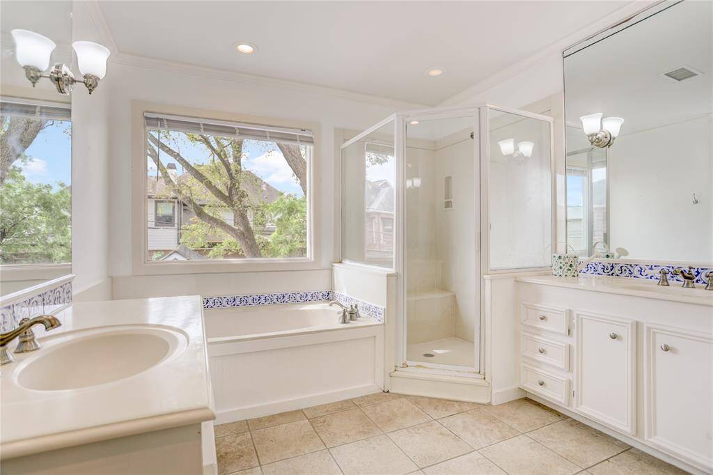 En-suite bath with a large window offering serene views of the oak trees surrounding the property.