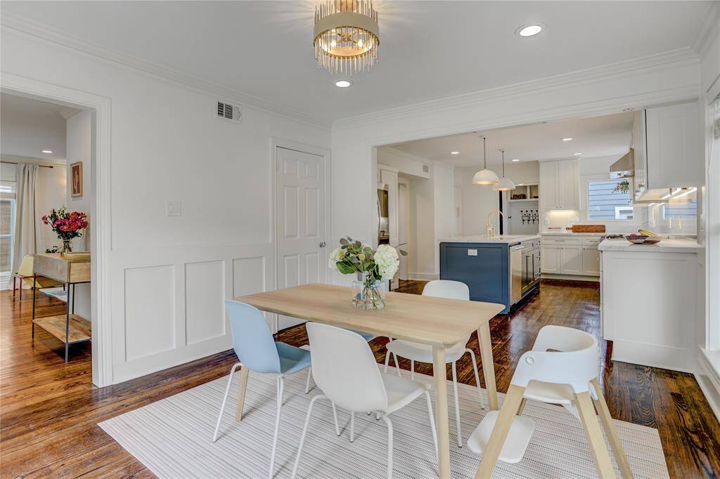 Open-concept kitchen flowing into a den/breakfast room, filled with natural light.