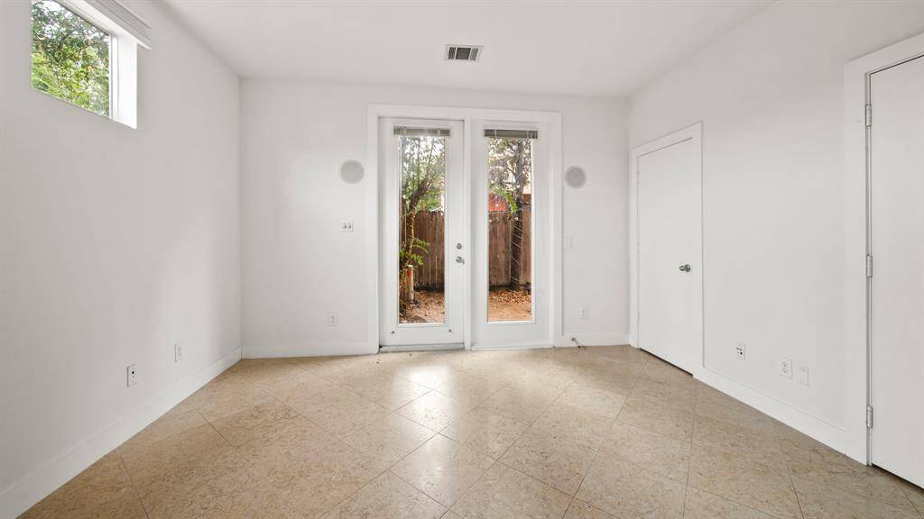 First-floor bedroom with an en-suite bathroom and direct access to the back patio, offering privacy and convenience.
