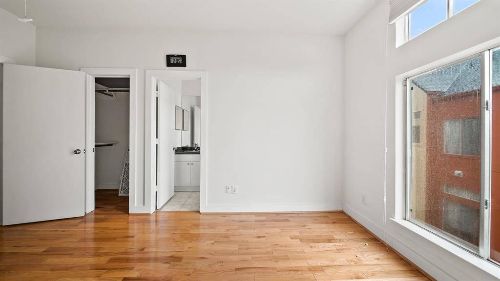 Antoher angle angle of the secondary bedroom on the third floor featuring a generous sized walk in closet and it's own en-suite bathroom.