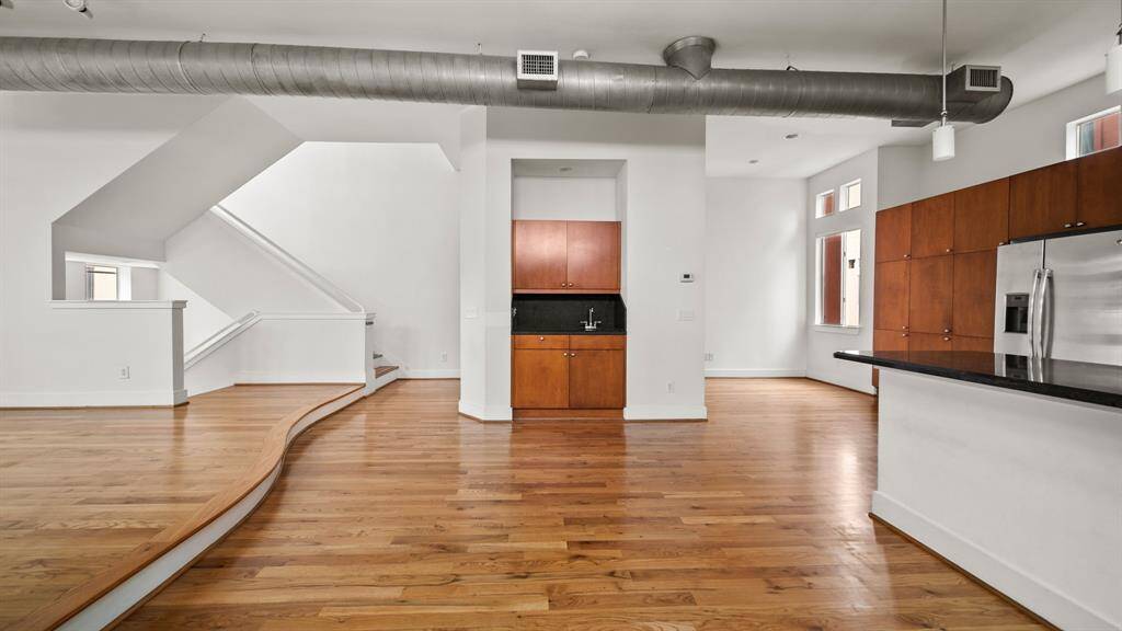 Chic wet bar nestled between the living room and kitchen, perfect for entertaining and easy access.