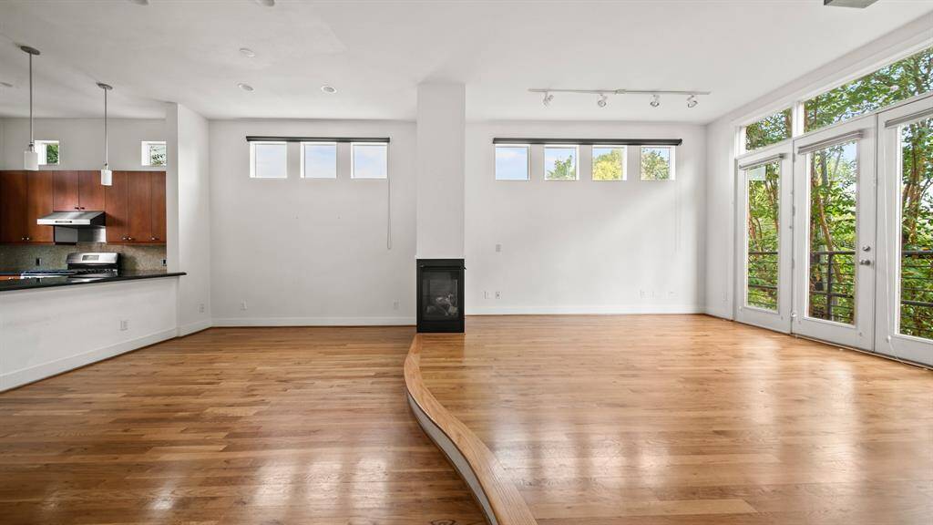 Spacious living room set apart by a stylish step-down design, adding depth and character to the open layout.