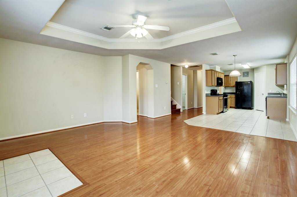 Spacious living room without staging. The photo does not show the new refrigerator.
