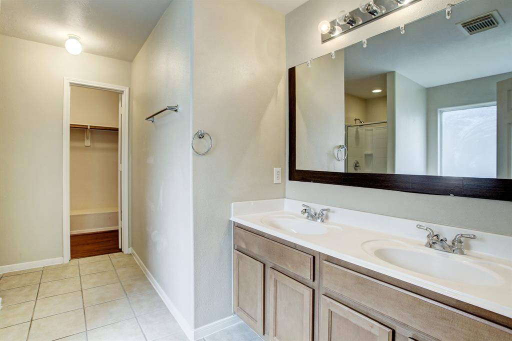 Large Master bathroom with two vanities and walking closet.