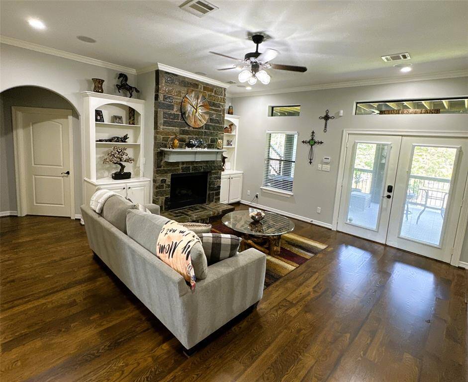 Cozy downstairs living area with a propane fireplace and elegant French doors opening to the lower porch.