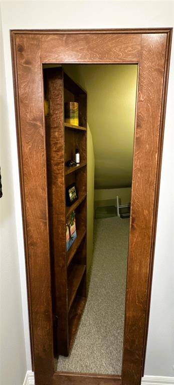 Discover a cleverly concealed storage area behind the shelves in the half bath.