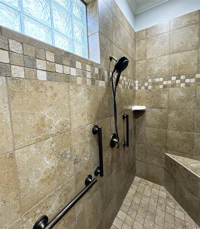 Primary bath shower with a stylish tile bench seat.