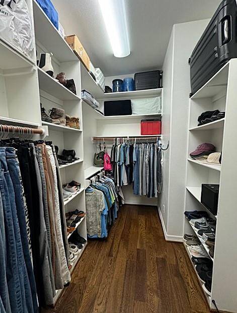 Spacious walk-in closet with ample shelving and hanging space, perfect for organizing your wardrobe.