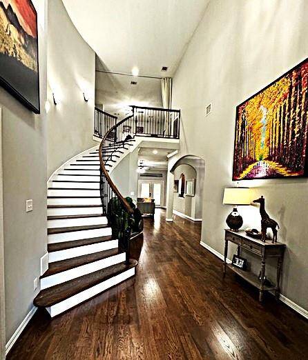 Welcome home to elegant curved stairs and rich wood flooring, creating a stunning entryway.