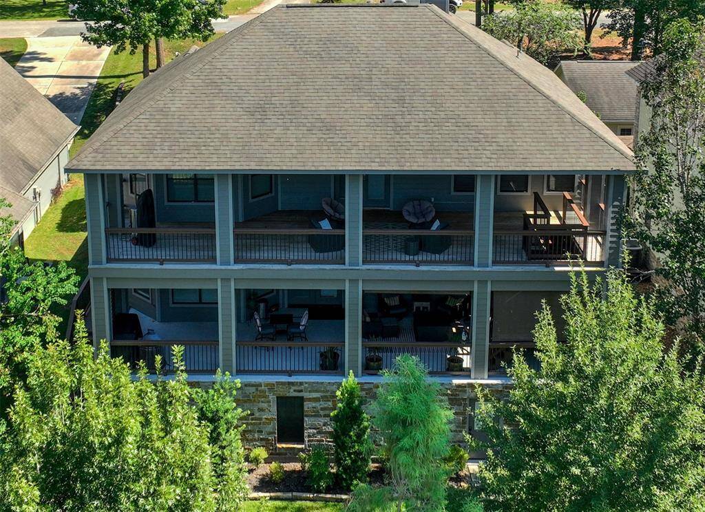 Stunning drone view highlighting spacious upper and lower porches, perfect for relaxation and entertaining.