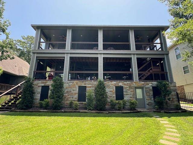 Elegant rear view with stepping stones leading to the elevator hallway and quick access to the lower porch via left-side stairs. Features a solar-powered, remote-controlled gate on the right for added convenience.