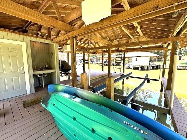 Enjoy seamless waterfront living with a convenient fish cleaning station, boat lift, and easy access to the spacious boathouse storage room.