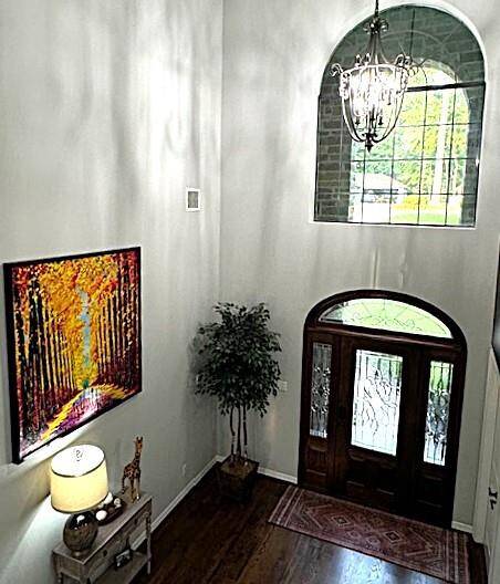 Elegant entrance view from the top of a grand curved staircase.