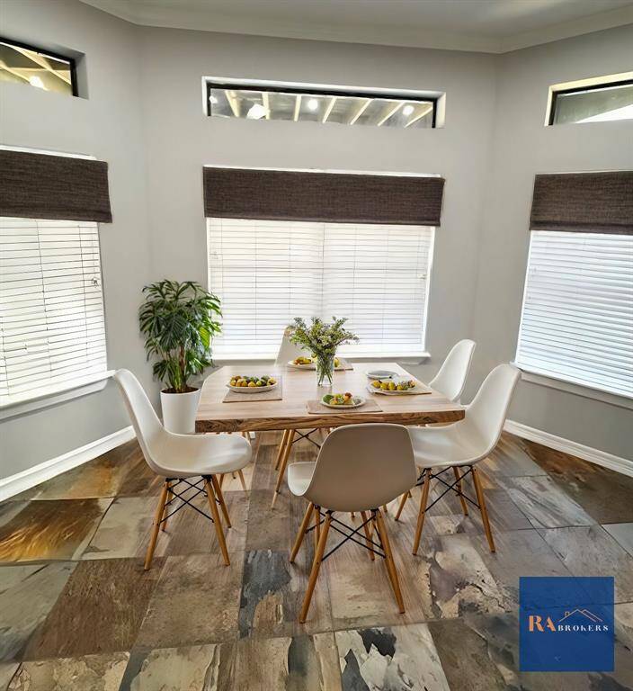 Breakfast area at the end of the large island overlooking the lower porch. (virtually staged)