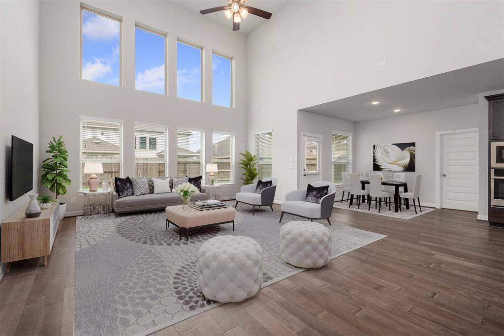 Sun drenched family room with wall of windows to the ceiling. Virtually staged.