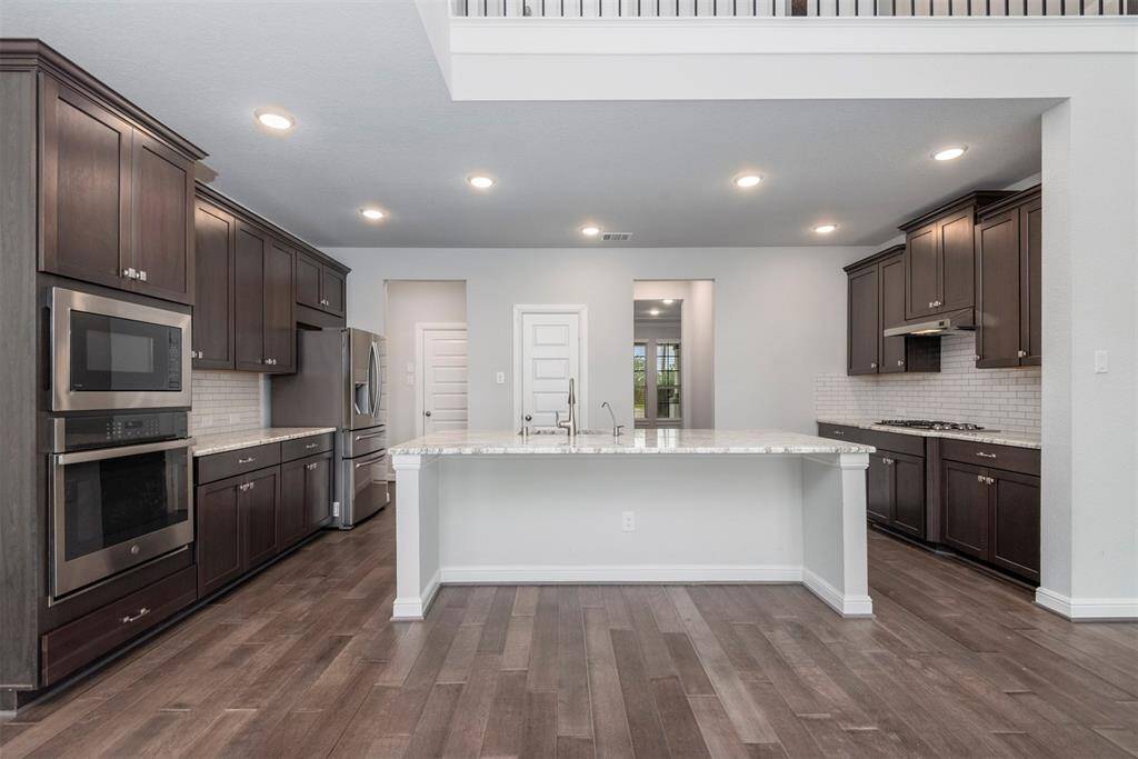 Warm and inviting island kitchen with bar seating