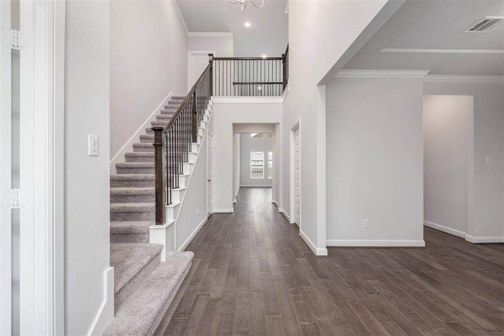 Grand entrance with soaring ceilings and gorgeous wood floors