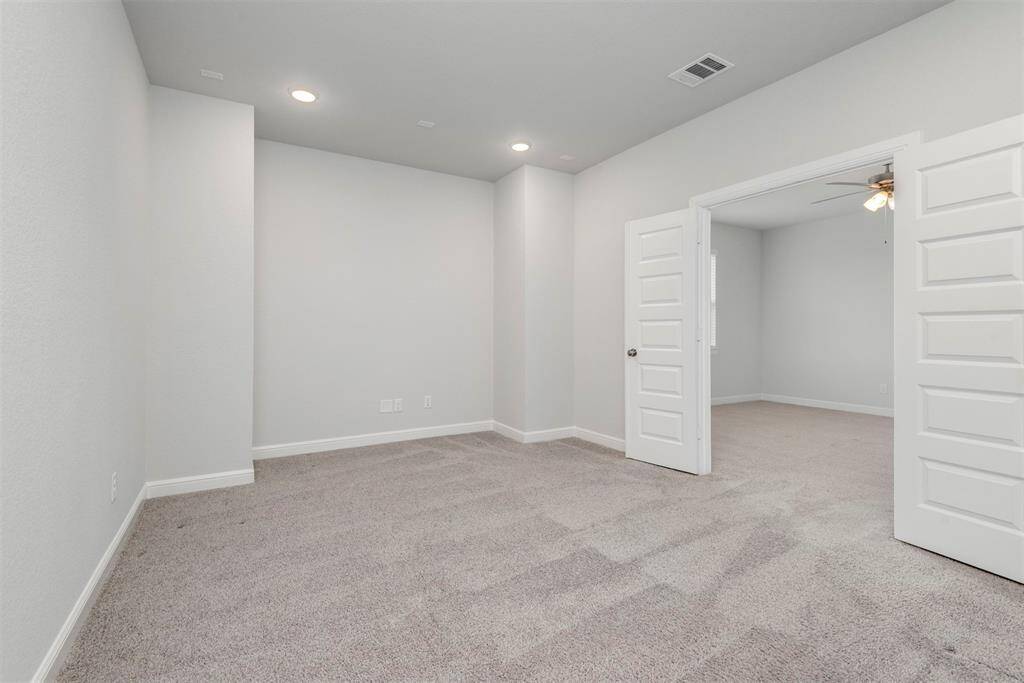 Another view of media room with double doors.