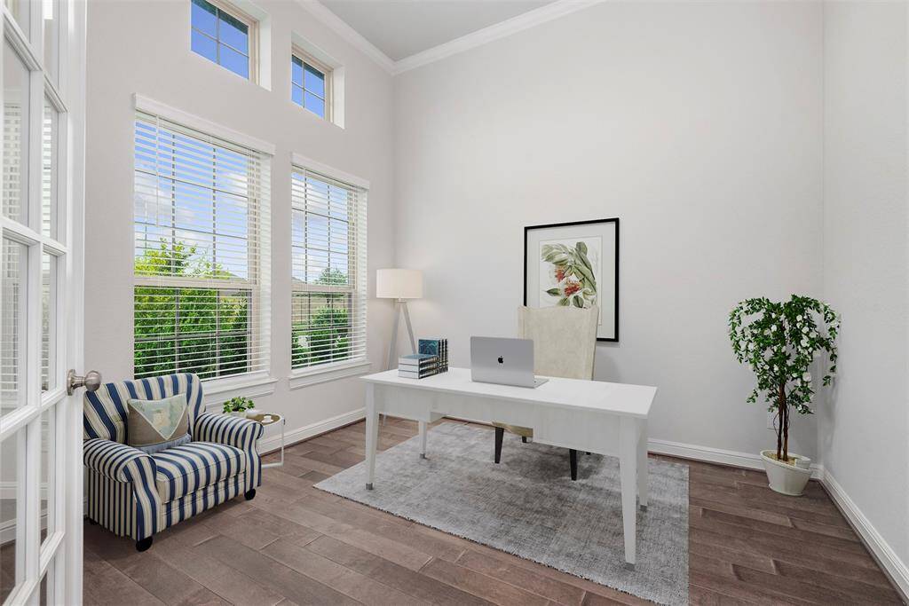 Study with tall ceilings, crown molding and double glass French doors. Virtually staged.