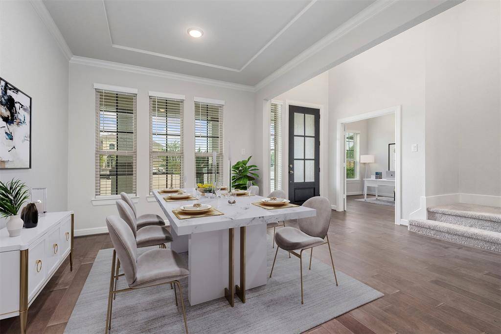 Formal dining with crown molding. Virtually staged.