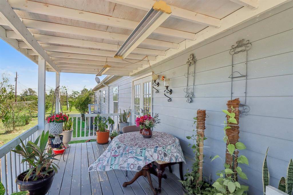 Back covered porch  with space for outdoor dining and relaxation.