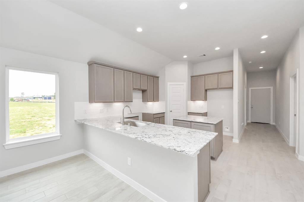 The extended counter area adds both practicality and style, making meal preparation a breeze. Every detail is thoughtfully designed to enhance the kitchen's functionality and aesthetic appeal.