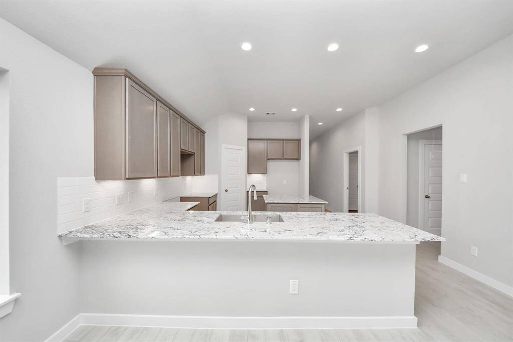 All of this overlooks your expansive family room, creating a perfect space for culinary delights and family gatherings.
