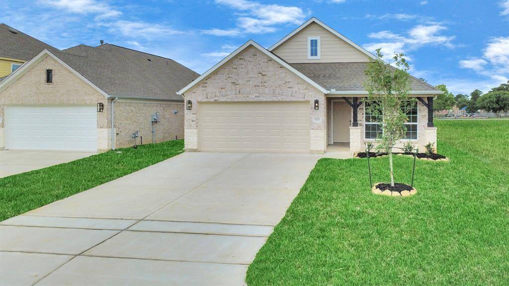 Meticulously maintained yard and lush landscape, paired with a premium elevation featuring captivating brick accents. Modern coach lights add a touch of contemporary elegance to the exterior.