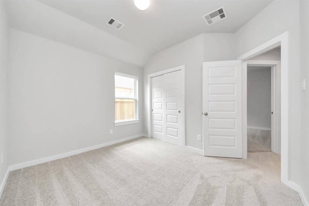 Generously sized secondary bedrooms featuring spacious closets, soft and inviting carpeting underfoot, large windows allowing plenty of natural light, and the added touch of privacy blinds for your personal retreat.