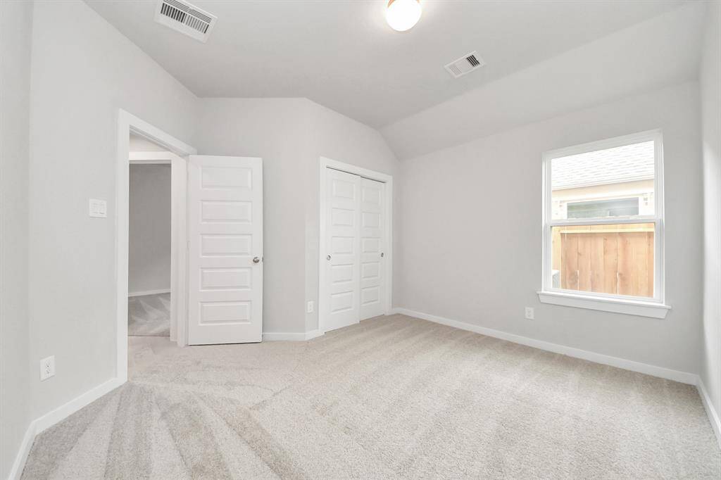 Generously sized secondary bedrooms featuring spacious closets, soft and inviting carpeting underfoot, large windows allowing plenty of natural light, and the added touch of privacy blinds for your personal retreat.