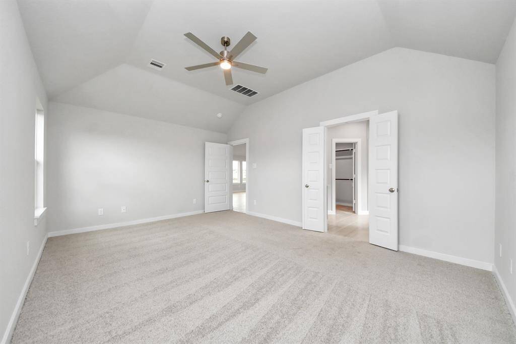 Come and unwind after a long day in this magnificent primary suite! This spacious room features plush carpet, warm paint, high ceilings and large windows with privacy blinds.