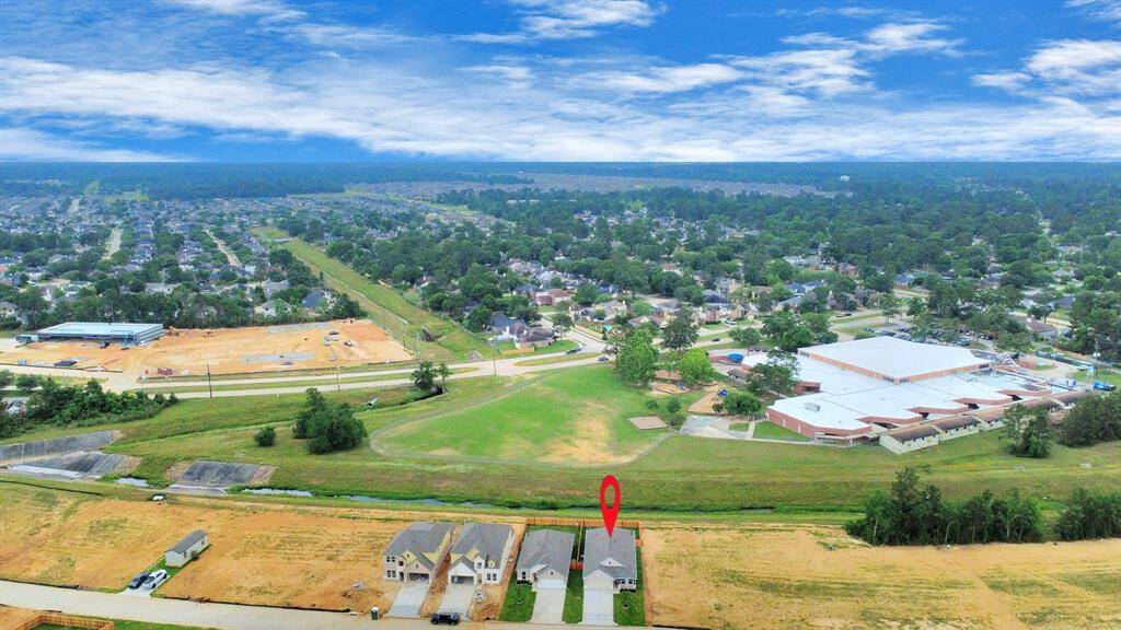 An aerial view of a spacious subdivision lot, highlighting a well-maintained yard and a fully fenced perimeter, offering both privacy and expansive outdoor space.