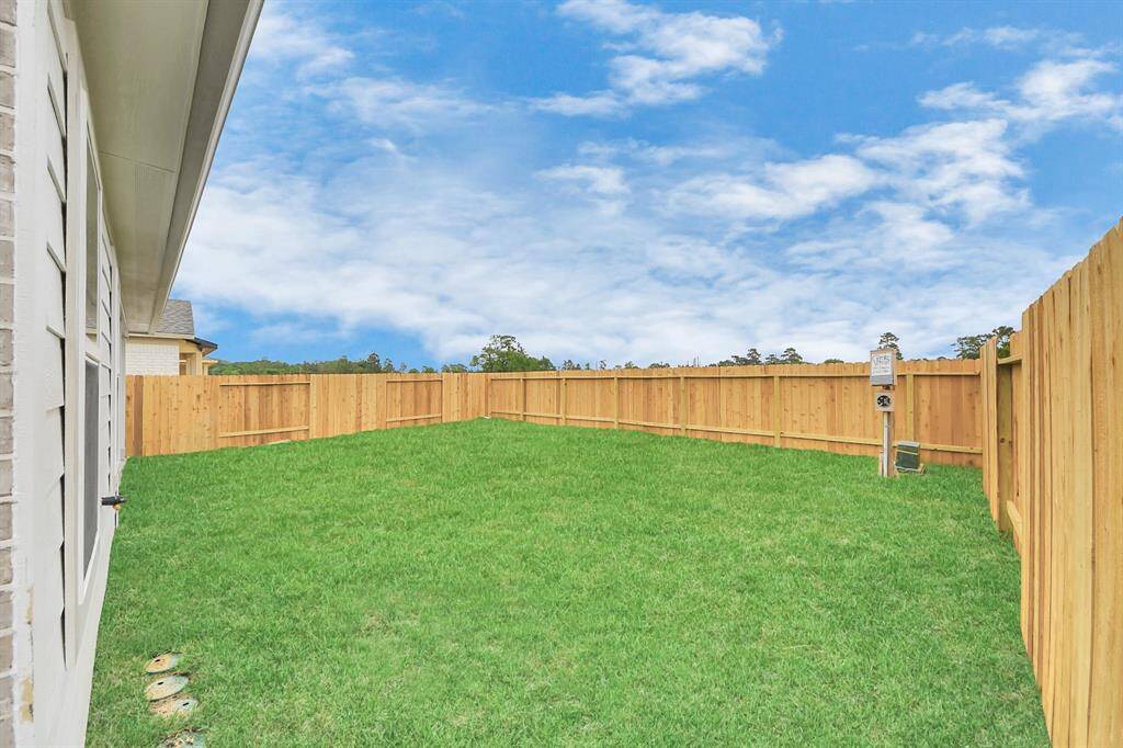 Discover the charm of this spacious backyard featuring a delightful covered patio!