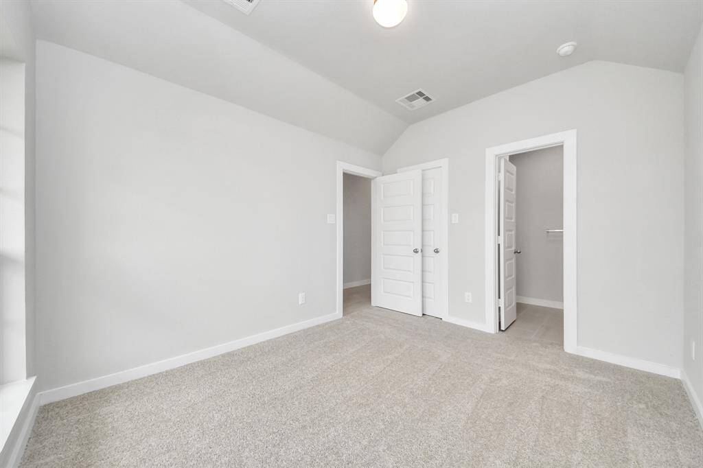 Generously sized secondary bedrooms featuring spacious closets, soft and inviting carpeting underfoot, large windows allowing plenty of natural light, and the added touch of privacy blinds for your personal retreat.
