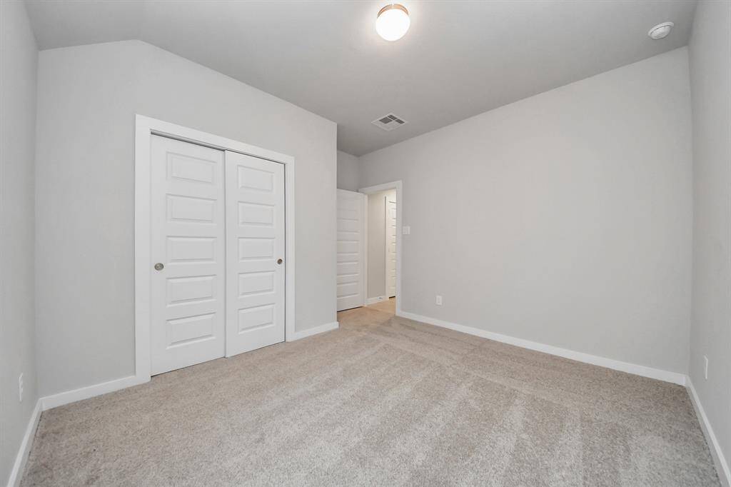 Generously sized secondary bedrooms featuring spacious closets, soft and inviting carpeting underfoot, large windows allowing plenty of natural light, and the added touch of privacy blinds for your personal retreat.