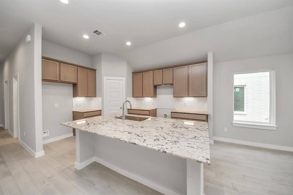 This kitchen offers both style and practicality. All this opens up to the expansive family room, creating a perfect hub for gatherings.