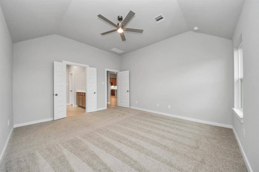 Come and unwind after a long day in this magnificent primary suite! This spacious room features plush carpet, warm paint, high ceilings and large windows with privacy blinds.