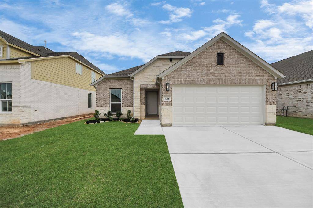 Meticulously maintained yard and lush landscape, paired with a premium elevation featuring captivating brick accents. Modern coach lights add a touch of contemporary elegance to the exterior.