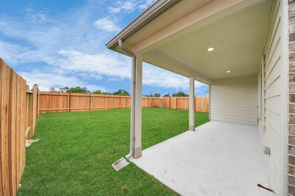Discover the charm of this spacious backyard featuring a delightful covered patio