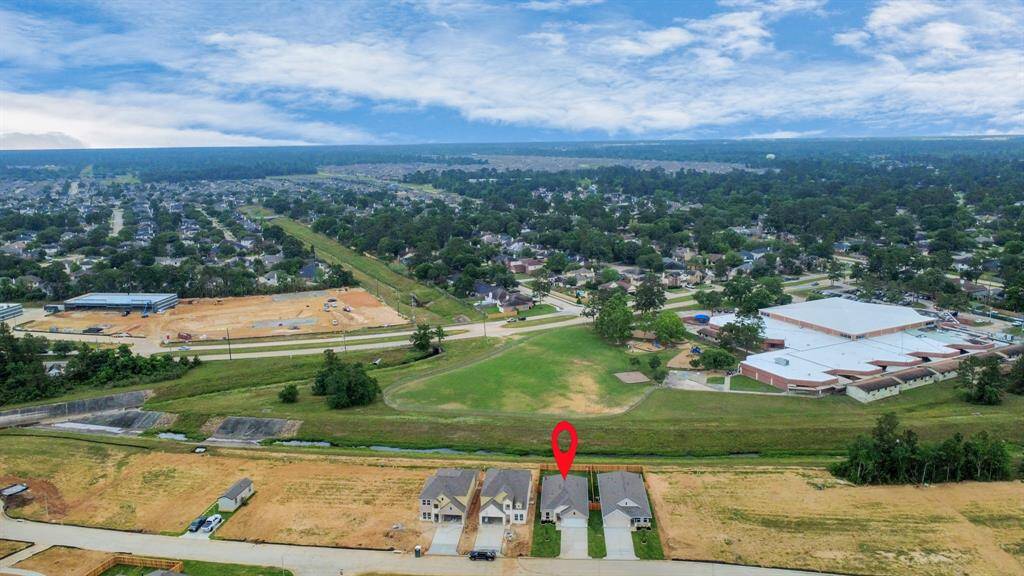 An aerial view of a spacious subdivision lot, highlighting a well-maintained yard and a fully fenced perimeter, offering both privacy and expansive outdoor space.
