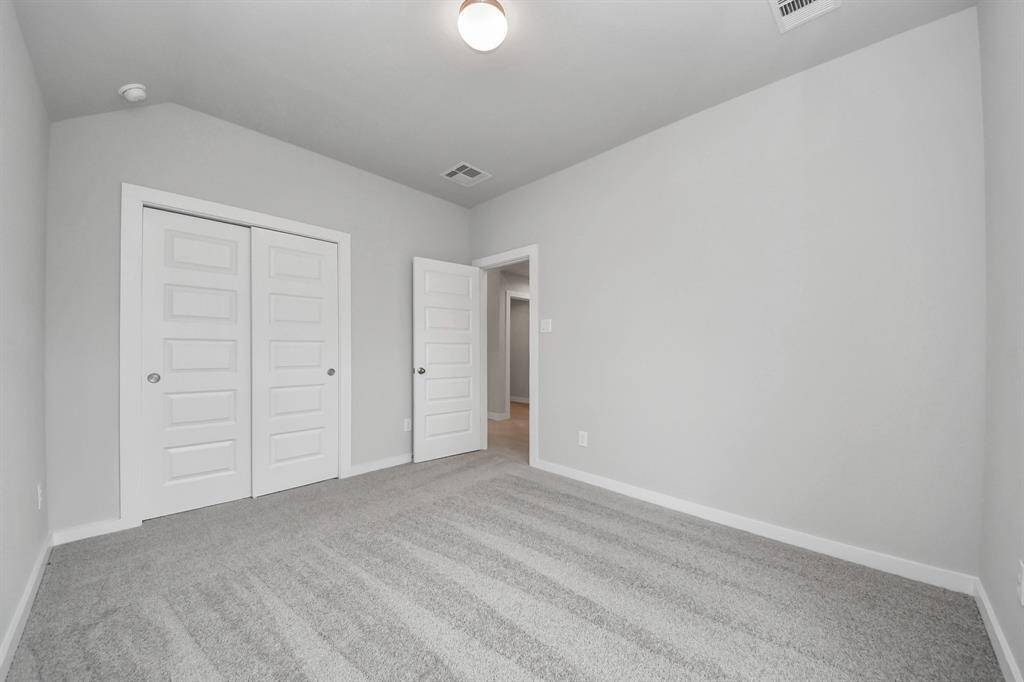 Generously sized secondary bedrooms featuring spacious closets, soft and inviting carpeting underfoot, large windows allowing plenty of natural light, and the added touch of privacy blinds for your personal retreat.
