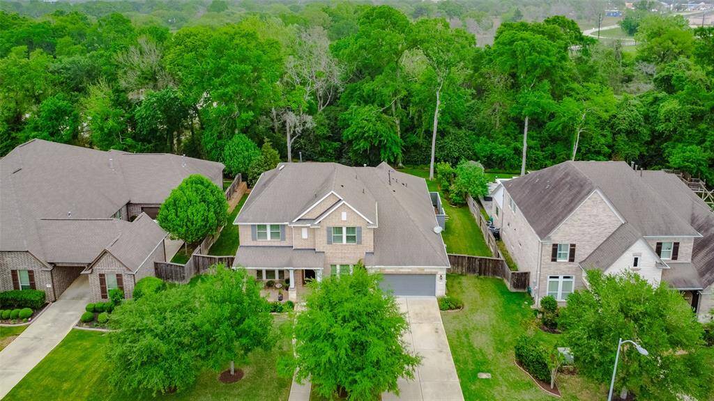 Soar above this stunning property and take in the full grandeur from an awe-inspiring aerial perspective. Surrounded by lush greenery, the property is beautifully framed by mature trees and natural landscaping, creating a peaceful, park-like setting.