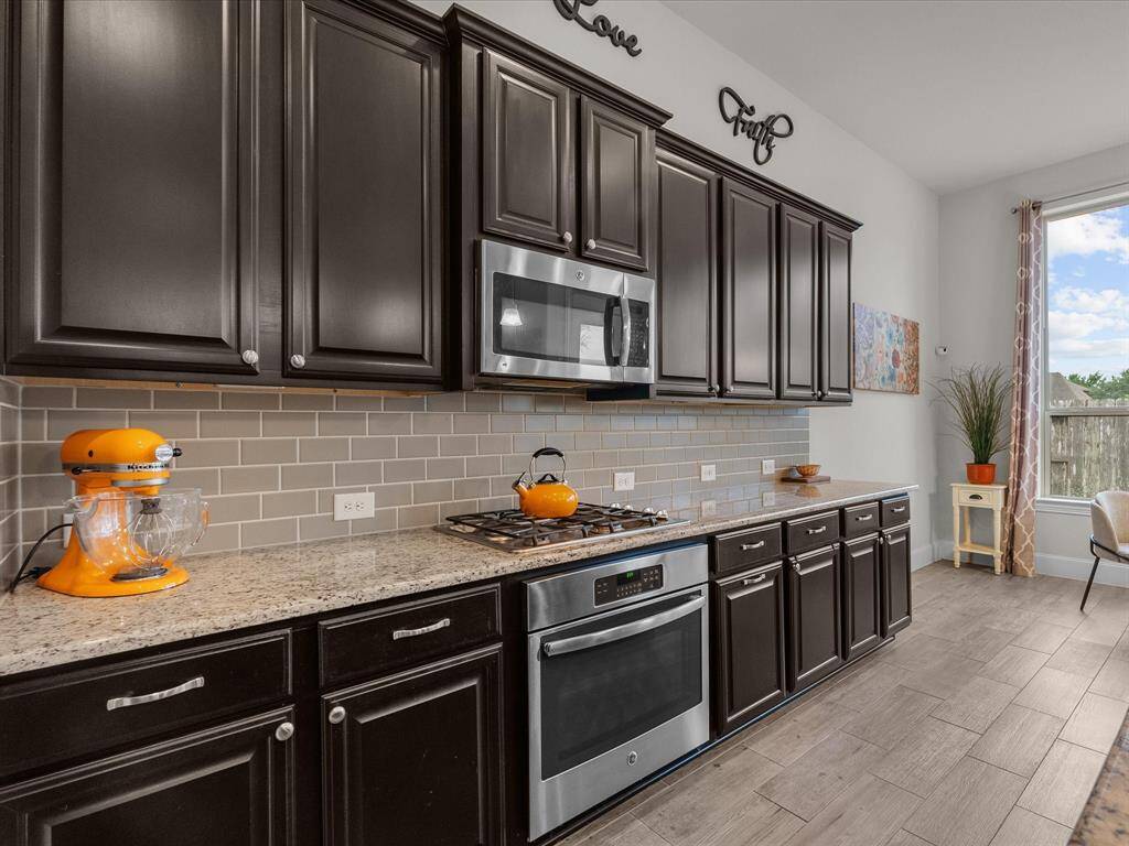 The stainless oven is electric, and the stove is gas-powered.