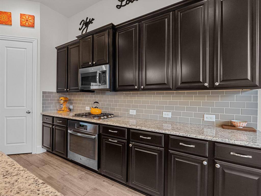 The kitchen is blessed with plenty of cabinets, counter space, and large pantry.