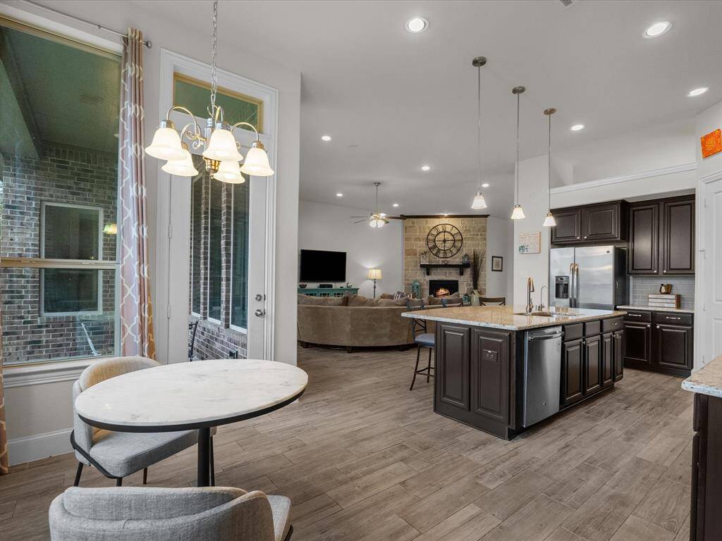 View from the corner of the breakfast room, over the kitchen island and into the family room.
