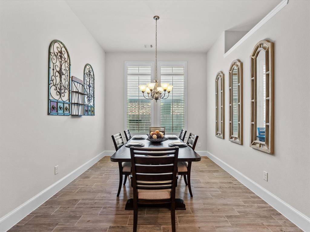 The dining area is elegant and well-lit. This home features 6 inch baseboards throughout for a luxurious touch.