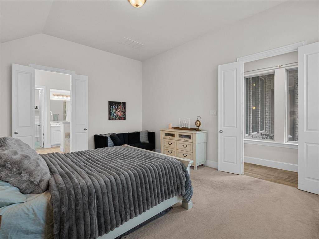 Another view of the bedroom, its natural light, and the entrance to the spa-like en-suite!