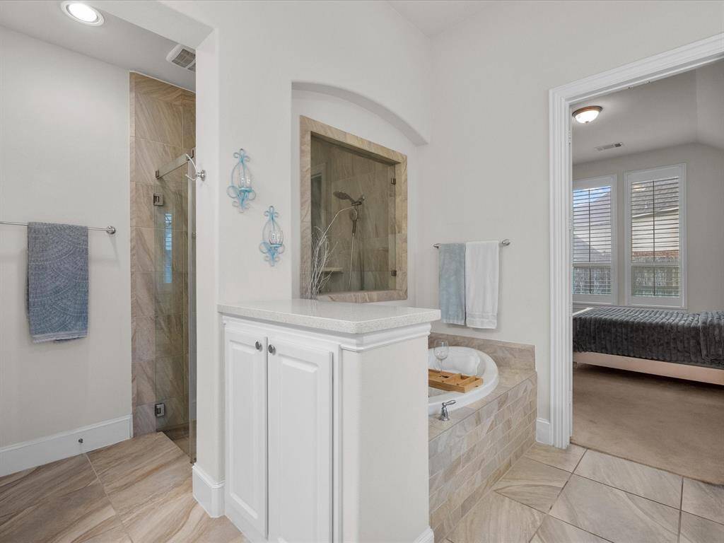 Behind the large soaking tub is a spacious walk-in shower.
