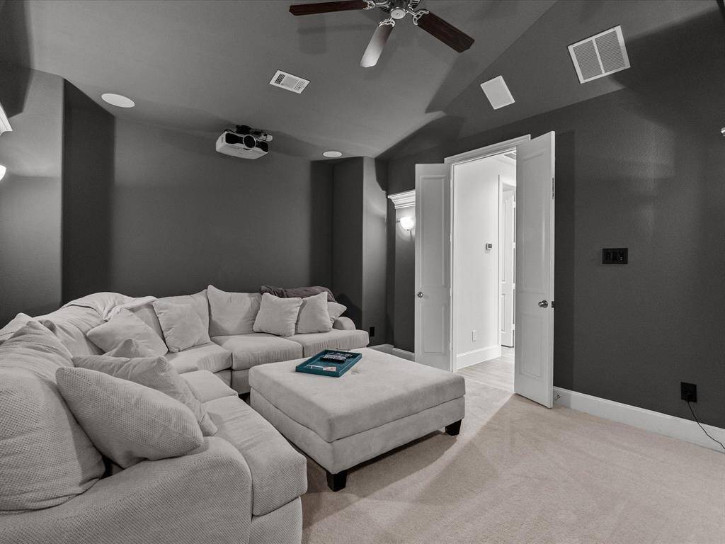 The media room is finished with a darker color palette to give a cinema feel. Projector and screen to remain!
